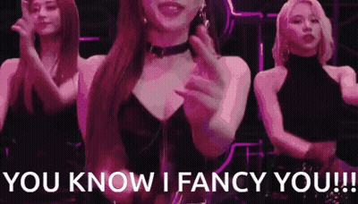 A Woman In A Choker Is Dancing With Two Other Women . GIF