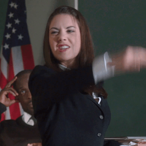 A Woman In A Classroom With The Word Booyah Written On The Screen GIF
