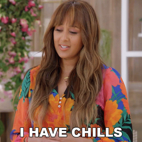 A Woman In A Colorful Floral Shirt Says I Have Chills GIF