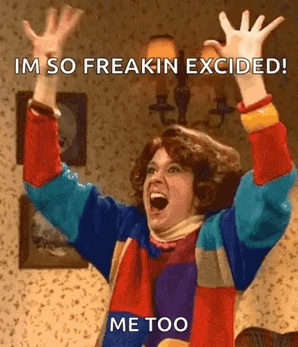 A Woman In A Colorful Sweater Is Screaming With Her Arms In The Air And Says Im So Freakin Excited Me Too GIF