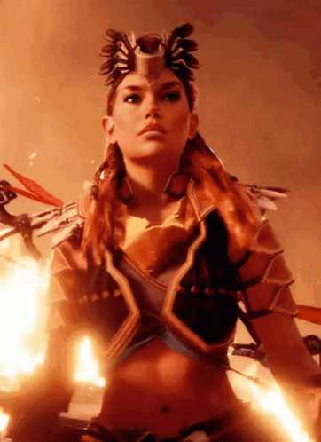 A Woman In A Costume Is Standing In Front Of A Fireball GIF