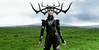 A Woman In A Costume With Horns On Her Head Is Standing In A Field . GIF