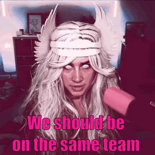 A Woman In A Costume With The Words We Should Be On The Same Team Written Below Her GIF