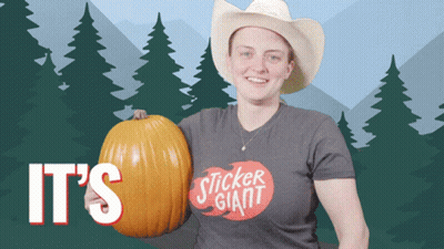 A Woman In A Cowboy Hat Is Holding A Pumpkin That Says It 'S Sticker Giant On It GIF