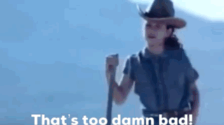 A Woman In A Cowboy Hat Is Holding A Stick And Says That 'S Too Damn Bad . GIF