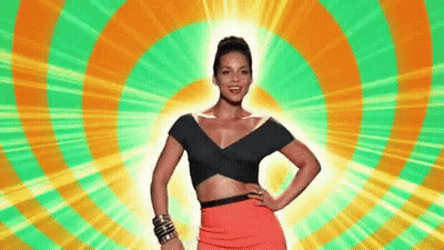 A Woman In A Crop Top And A Red Skirt Is Standing In Front Of A Colorful Circle . GIF