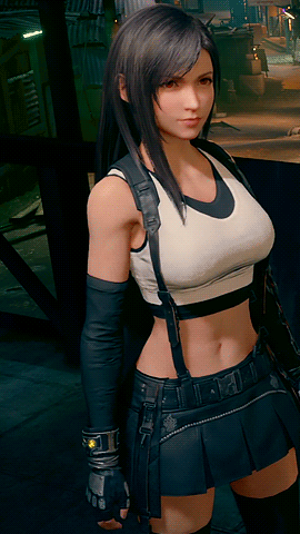 A Woman In A Crop Top And Black Skirt Stands In Front Of A Wall GIF
