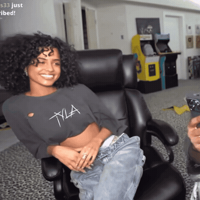 A Woman In A Crop Top With The Letter Xla On It GIF