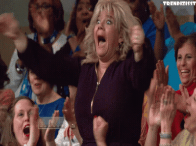 A Woman In A Crowd With The Word Trendizissy On The Bottom Left GIF