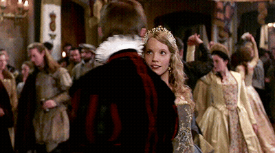 A Woman In A Crown Is Dancing With A Man In A Black Jacket GIF
