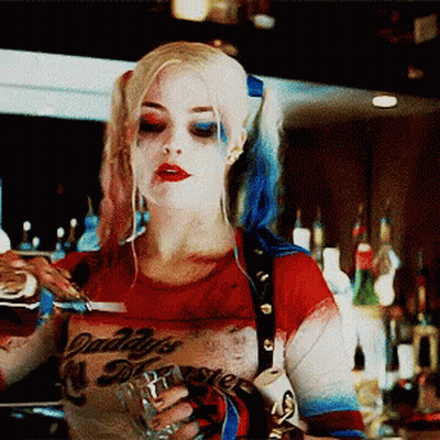 A Woman In A Daddy 'S Monster Costume Pours A Drink Into A Glass GIF