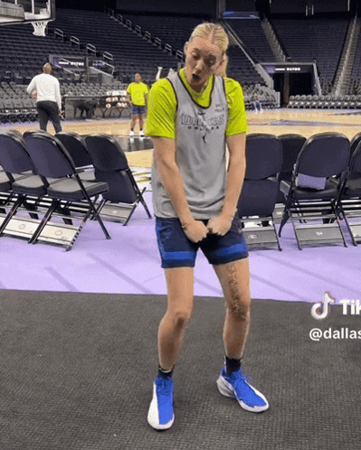 A Woman In A Dallas Jersey Is Standing On A Basketball Court GIF