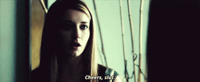 A Woman In A Dark Room Says Cheers , Slut GIF