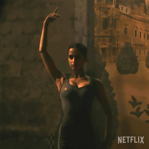 A Woman In A Dark Room With A Netflix Logo On The Bottom Right GIF