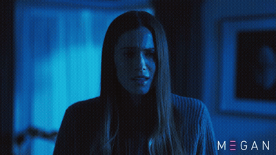 A Woman In A Dark Room With The Name Megan On The Bottom Right GIF