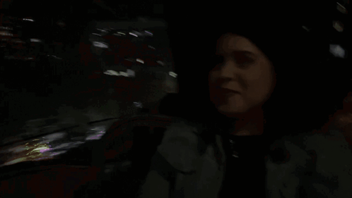 A Woman In A Dark Room With The Word Not Written In Pink GIF