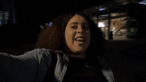 A Woman In A Dark Room With The Word Scared Written Above Her GIF