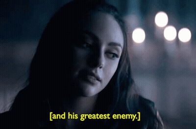 A Woman In A Dark Room With The Words " And His Greatest Enemy " Above Her GIF