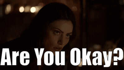A Woman In A Dark Room With The Words " Are You Okay " On The Bottom GIF