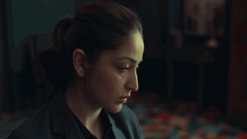 A Woman In A Dark Room With The Words Beware On The Bottom Right GIF