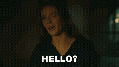A Woman In A Dark Room With The Words Hello On The Bottom GIF