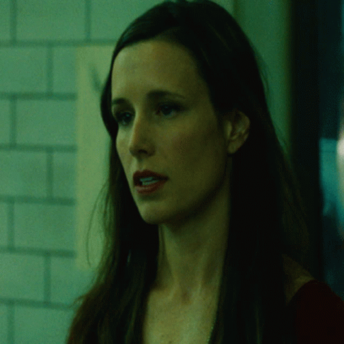 A Woman In A Dark Room With The Words It 'S Begun Behind Her GIF