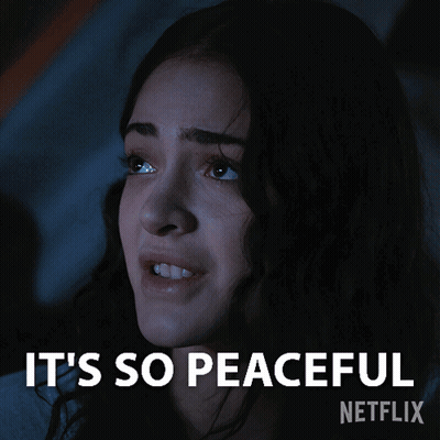 A Woman In A Dark Room With The Words It 'S So Peaceful Written Above Her GIF