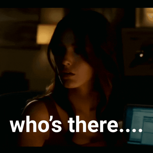 A Woman In A Dark Room With The Words Who 'S There On The Bottom GIF