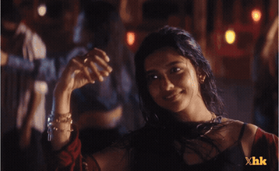 A Woman In A Dark Room With Xhk Written On The Bottom GIF