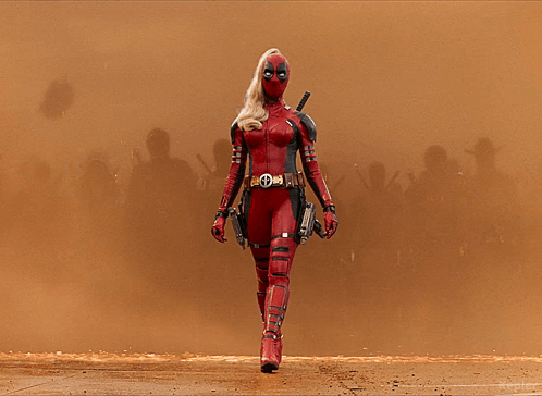 A Woman In A Deadpool Costume Holds A Gun GIF