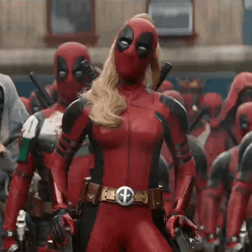 A Woman In A Deadpool Costume Is Standing Next To A Man In A Deadpool Costume . GIF