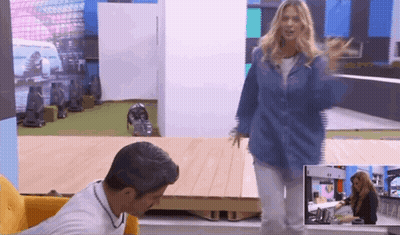 A Woman In A Denim Jacket Is Standing In Front Of A Man In A White Shirt GIF