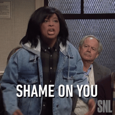 A Woman In A Denim Jacket Says " Shame On You " In Front Of A Group Of People GIF