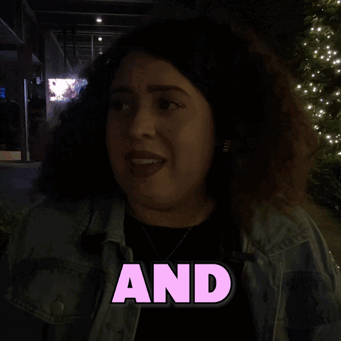 A Woman In A Denim Jacket With The Word Was Written On It GIF