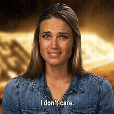 A Woman In A Denim Shirt Says I Don T Care GIF