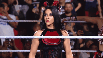 A Woman In A Devil Costume Is In A Wrestling Ring . GIF