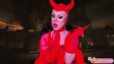 A Woman In A Devil Costume Is Sitting In A Chair With Her Mouth Open GIF