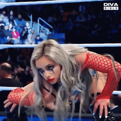 A Woman In A Diva Bible Outfit Is Kneeling Down In A Ring GIF