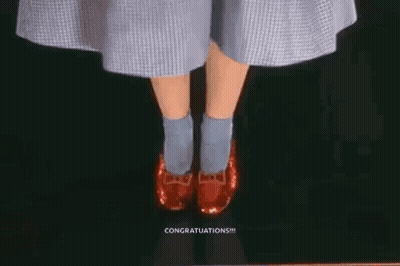 A Woman In A Dress And Blue Socks Is Wearing Red Shoes . GIF