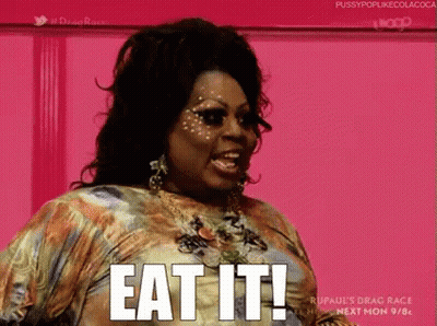A Woman In A Dress Is Saying Eat It . GIF