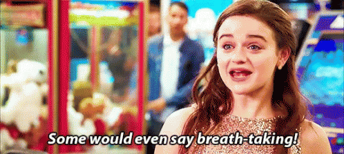 A Woman In A Dress Is Saying `` Some Would Even Say Breath-Taking '' In An Arcade . GIF