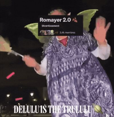 A Woman In A Fairy Costume Is Holding A Fan And Says Romayer 2.0 Delulu Is The Trululu GIF