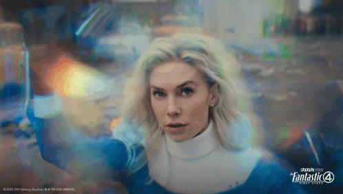 A Woman In A Fantastic 4 Costume Is Holding A Sword GIF