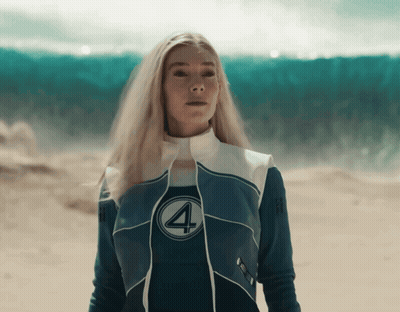 A Woman In A Fantastic Four Costume Stands In The Desert GIF