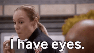 A Woman In A Firefighter Uniform Is Eating A Piece Of Food And Says `` I Have Eyes . '' GIF