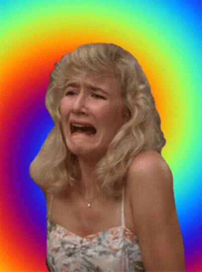 A Woman In A Floral Dress Is Crying Against A Rainbow Background GIF