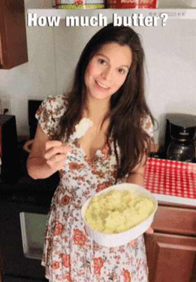A Woman In A Floral Dress Is Holding A Bowl Of Mashed Potatoes With The Caption How Much Butter GIF