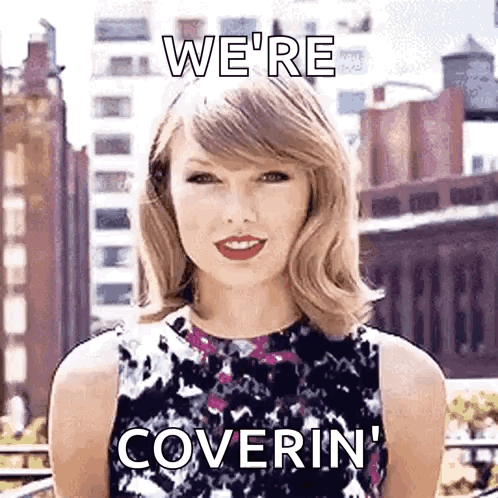 A Woman In A Floral Dress Is Standing In Front Of A City And Says `` We 'Re Coverin '' . GIF
