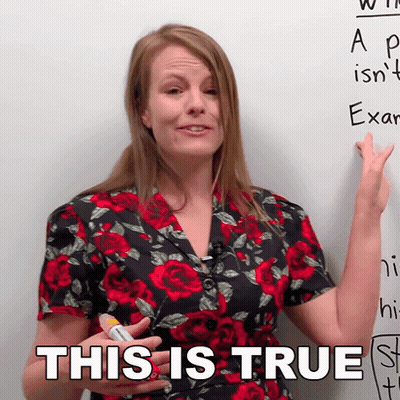 A Woman In A Floral Shirt Is Pointing At A White Board And Says This Is True GIF