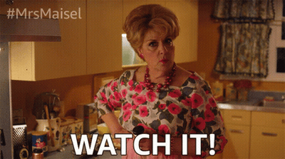 A Woman In A Floral Shirt Says Watch It In A Kitchen GIF